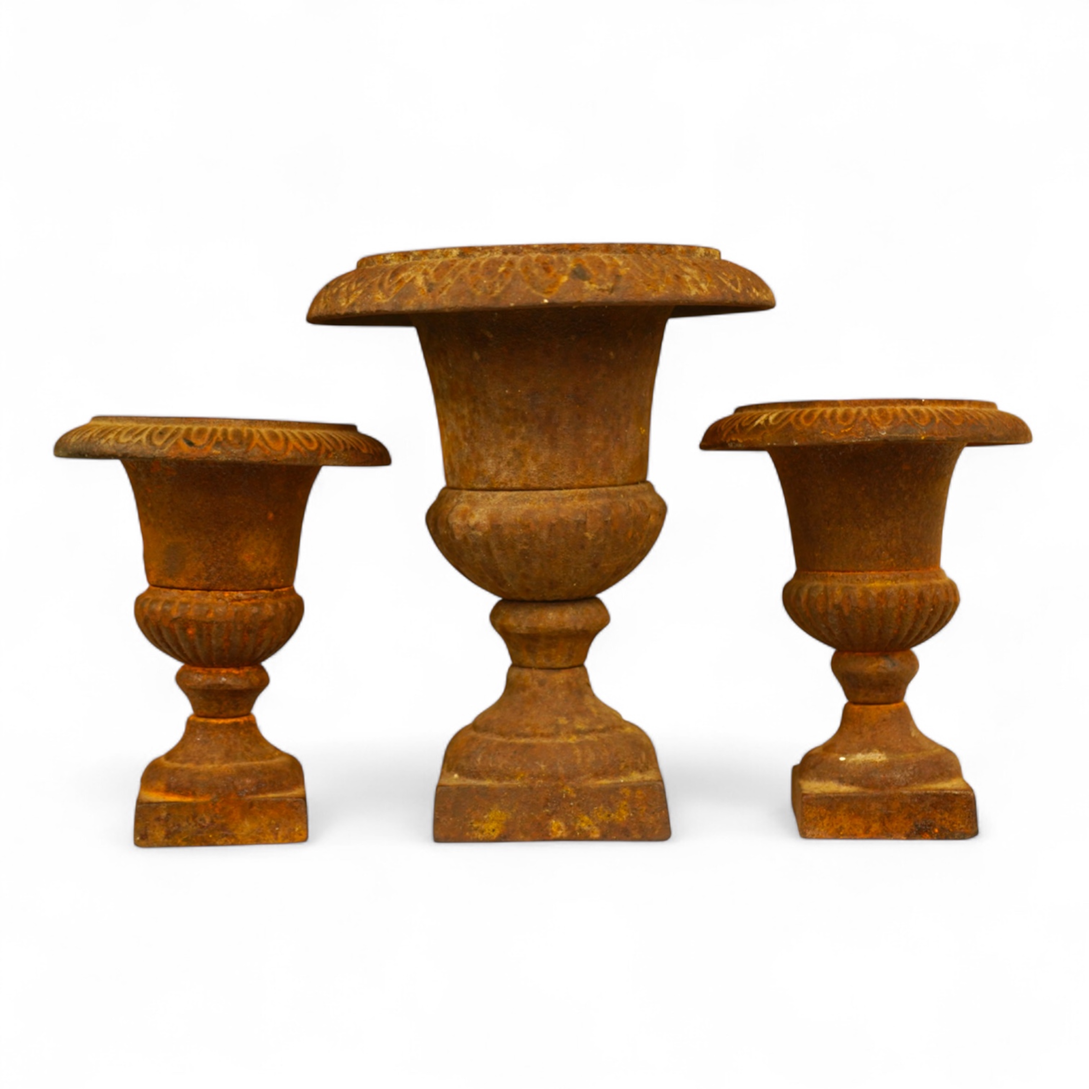 A garniture of three cast iron campana vases, largest 18cm high